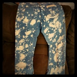 Distressed jeans carrot shape. Zippers on the bott